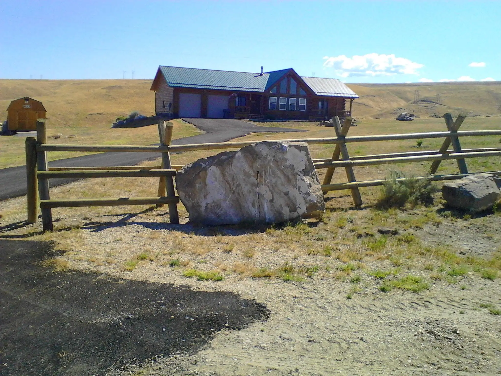 Jack leg buck and rail fence installed over rocky ground in Montana